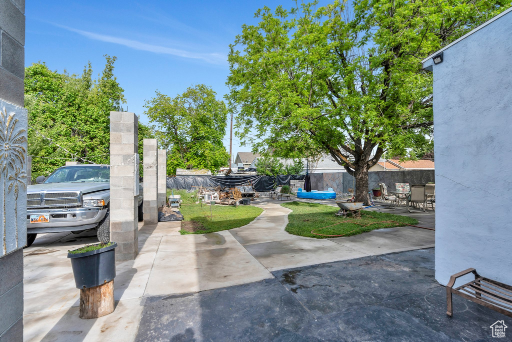View of patio featuring fence