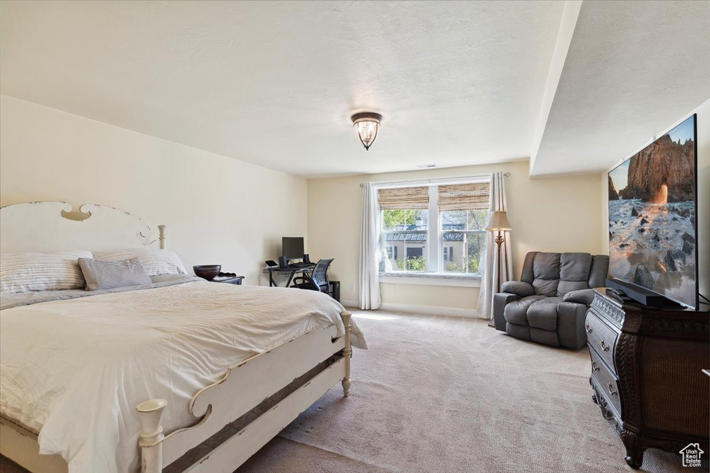 Bedroom with light colored carpet