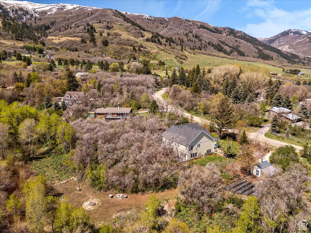 Aerial view of property and surrounding area with a mountain backdrop