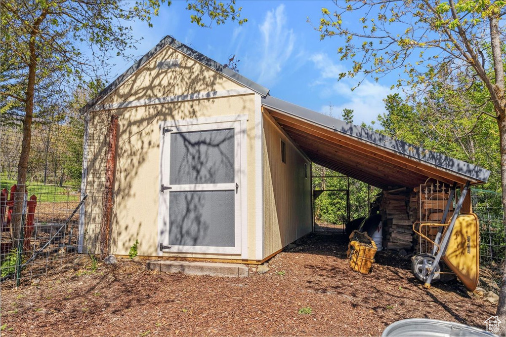 View of shed with a carport