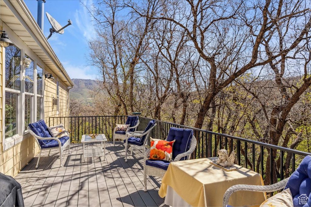 Wooden terrace with an outdoor living space and a mountain view