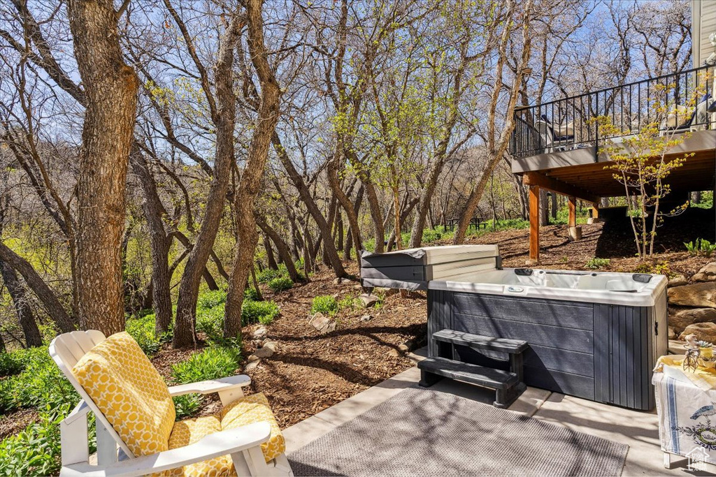 View of patio / terrace with a hot tub and a wooden deck