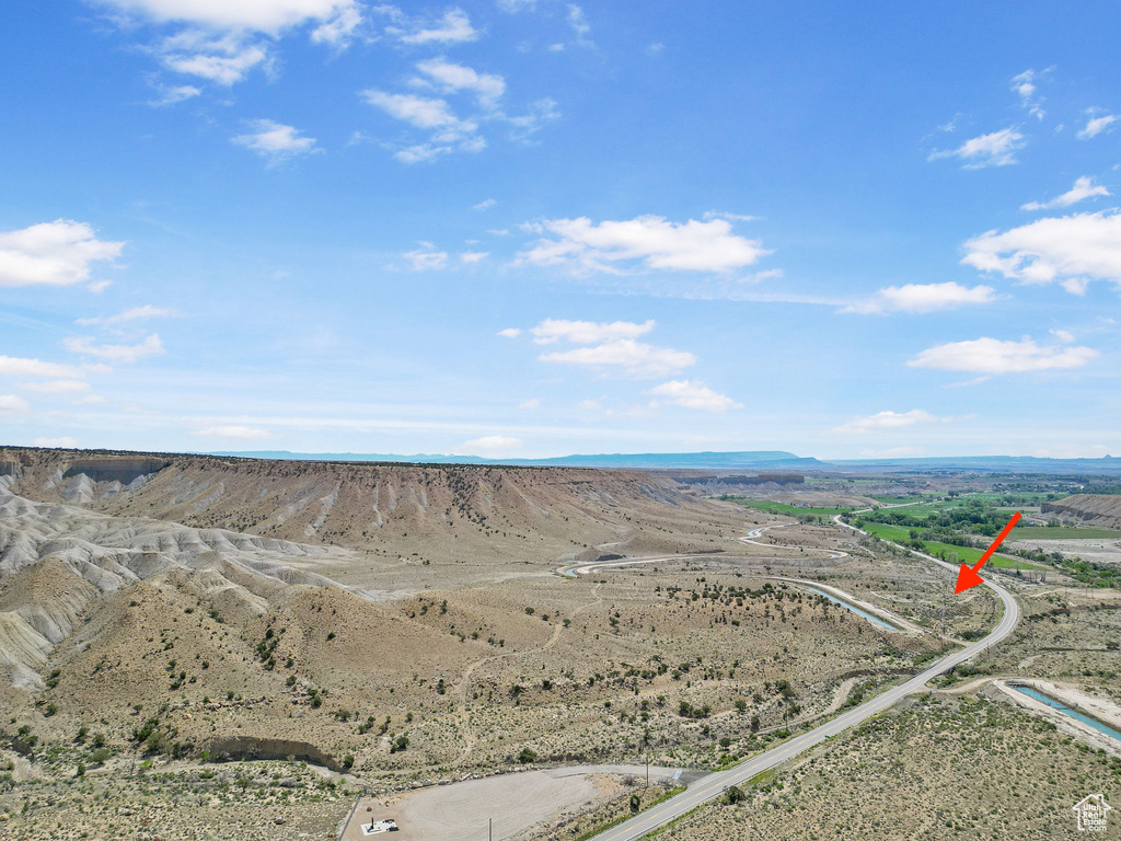 Aerial view of a desert landscape and a mountain backdrop