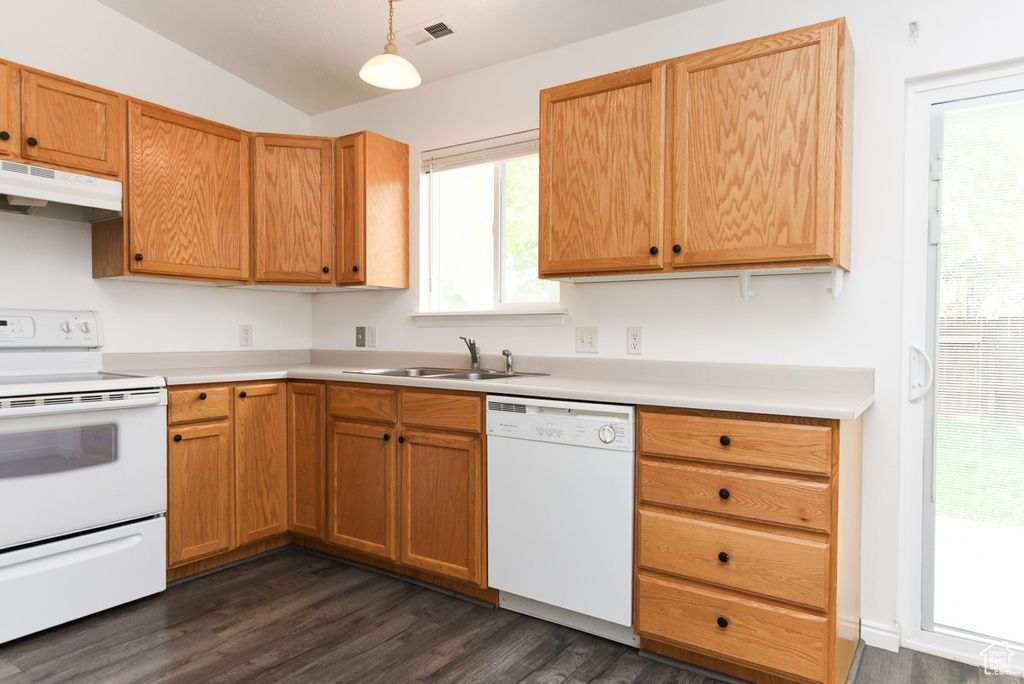 Kitchen featuring white appliances, a sink, under cabinet range hood, dark wood finished floors, and light countertops