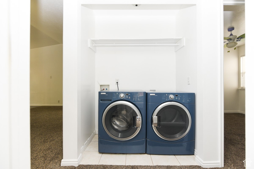 Laundry room featuring independent washer and dryer, baseboards, and carpet floors