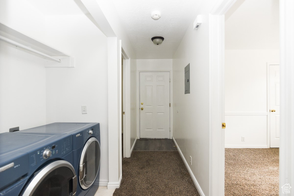 Washroom with washing machine and dryer, carpet floors, electric panel, and baseboards