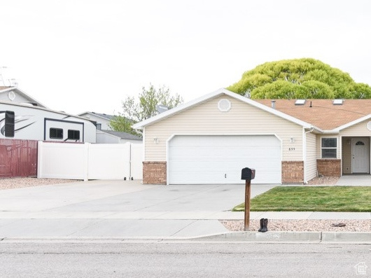 Ranch-style home with brick siding, concrete driveway, and a garage
