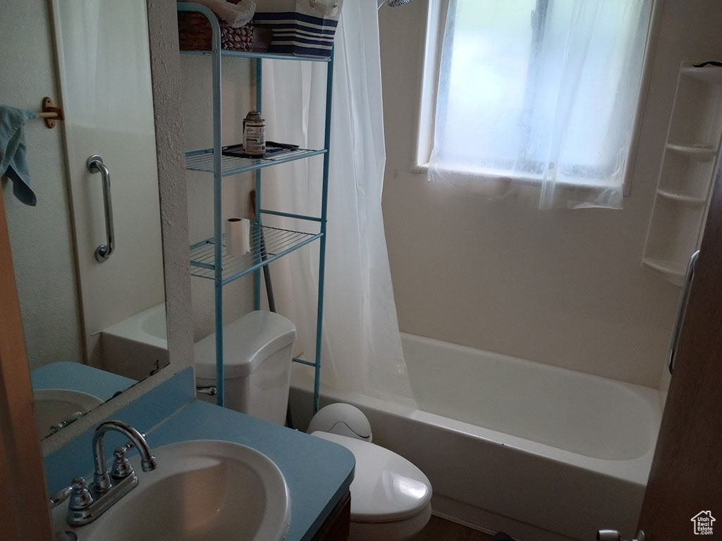 Full bath featuring toilet, shower / tub combo, and vanity