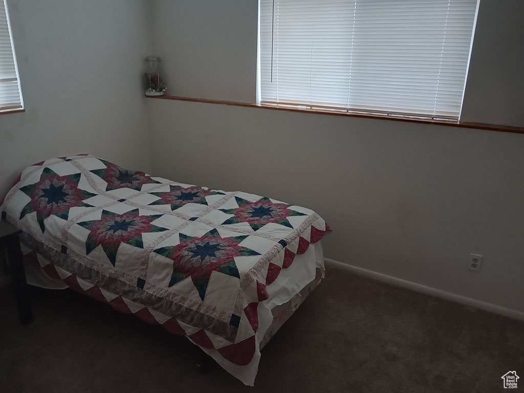 Carpeted bedroom with baseboards