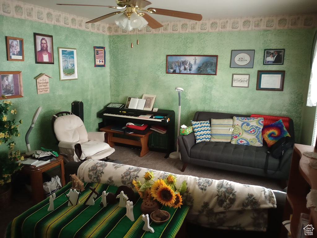 Living room with ceiling fan and carpet