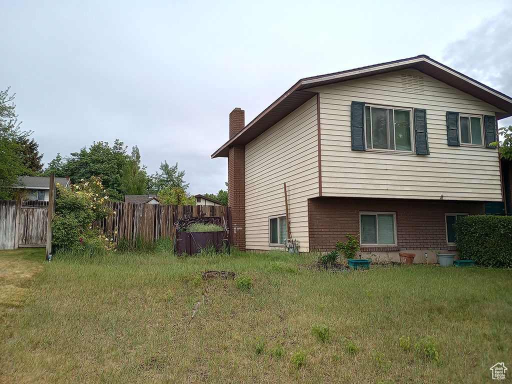 View of side of home featuring a chimney