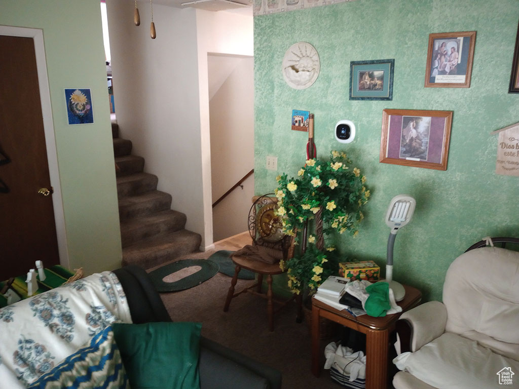 Sitting room with stairway and carpet floors