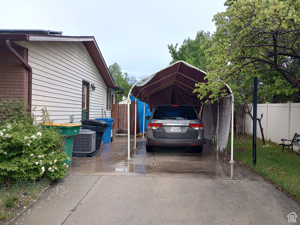 View of car parking with a carport and concrete driveway