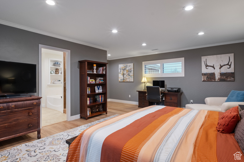 Bedroom featuring light wood finished floors, ornamental molding, recessed lighting, ensuite bath, and baseboards