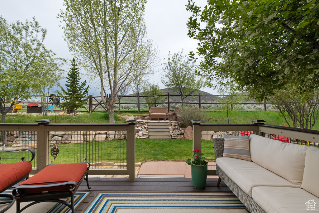 Wooden terrace featuring an outdoor hangout area