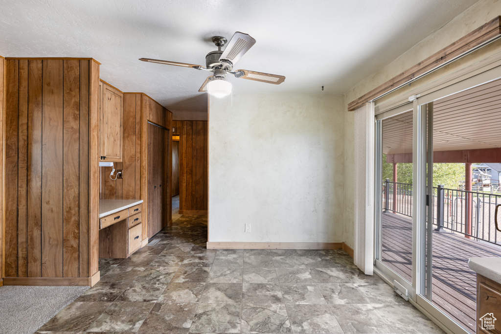 Interior space featuring baseboards, ceiling fan, and stone finish flooring