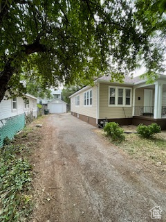 View of front of house featuring driveway and covered porch