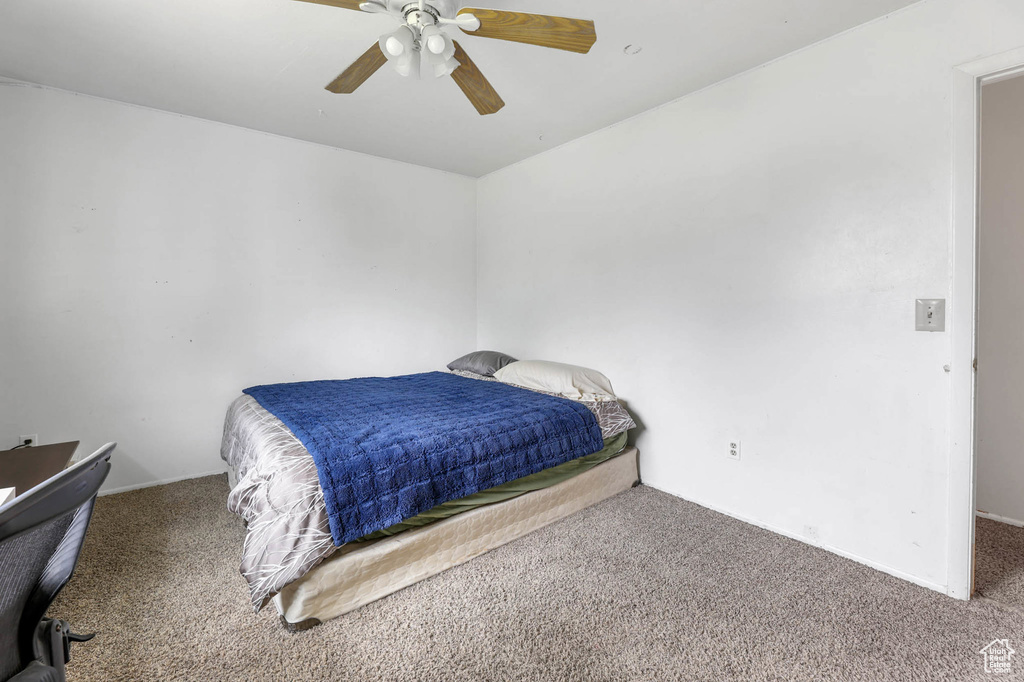 Bedroom with carpet flooring, ceiling fan, and baseboards