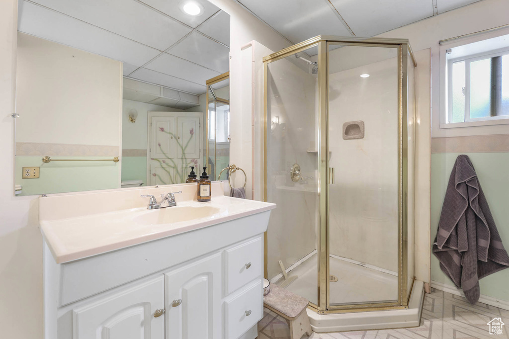 Full bathroom featuring a shower stall, vanity, and recessed lighting
