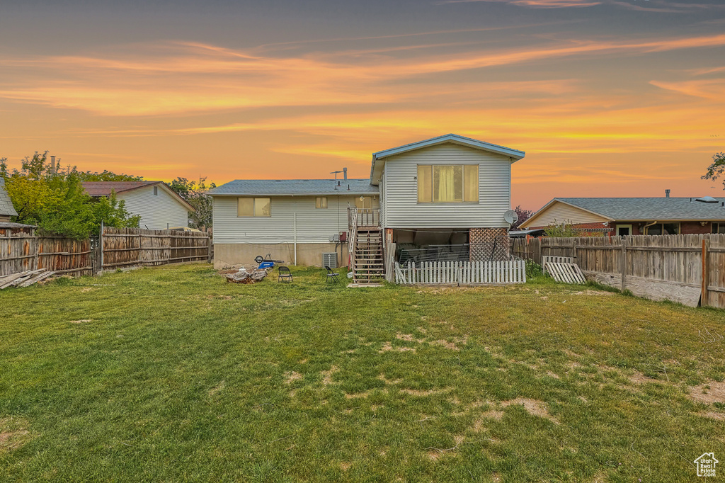 Back of house at dusk featuring stairway