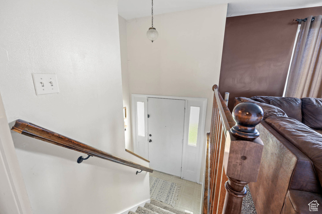 Foyer entrance with light floors and stairway