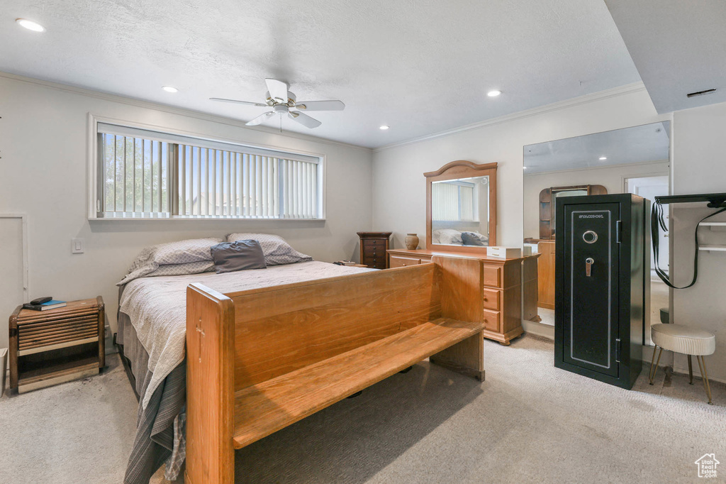 Bedroom with light carpet, crown molding, recessed lighting, and a ceiling fan