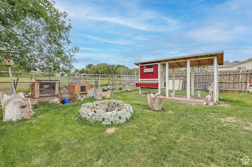View of yard featuring exterior structure and an outbuilding