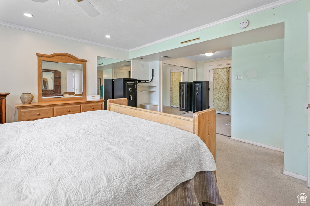 Bedroom with ornamental molding, light colored carpet, baseboards, a ceiling fan, and recessed lighting