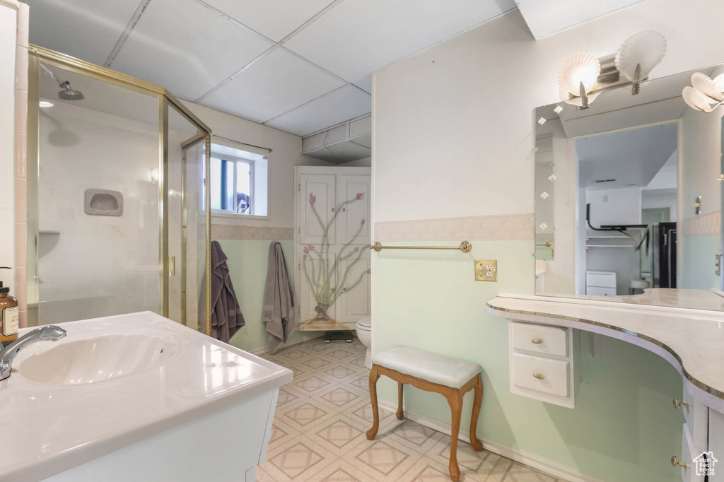 Full bathroom with a shower stall, vanity, tile patterned floors, and toilet