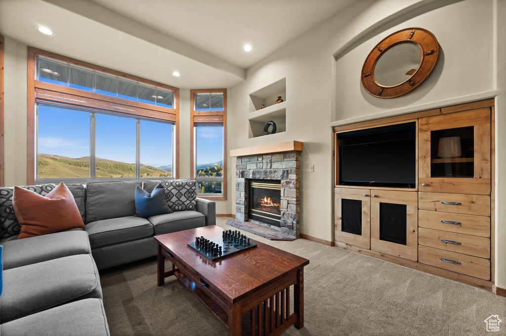 Carpeted living room with built in features, recessed lighting, a fireplace, and baseboards