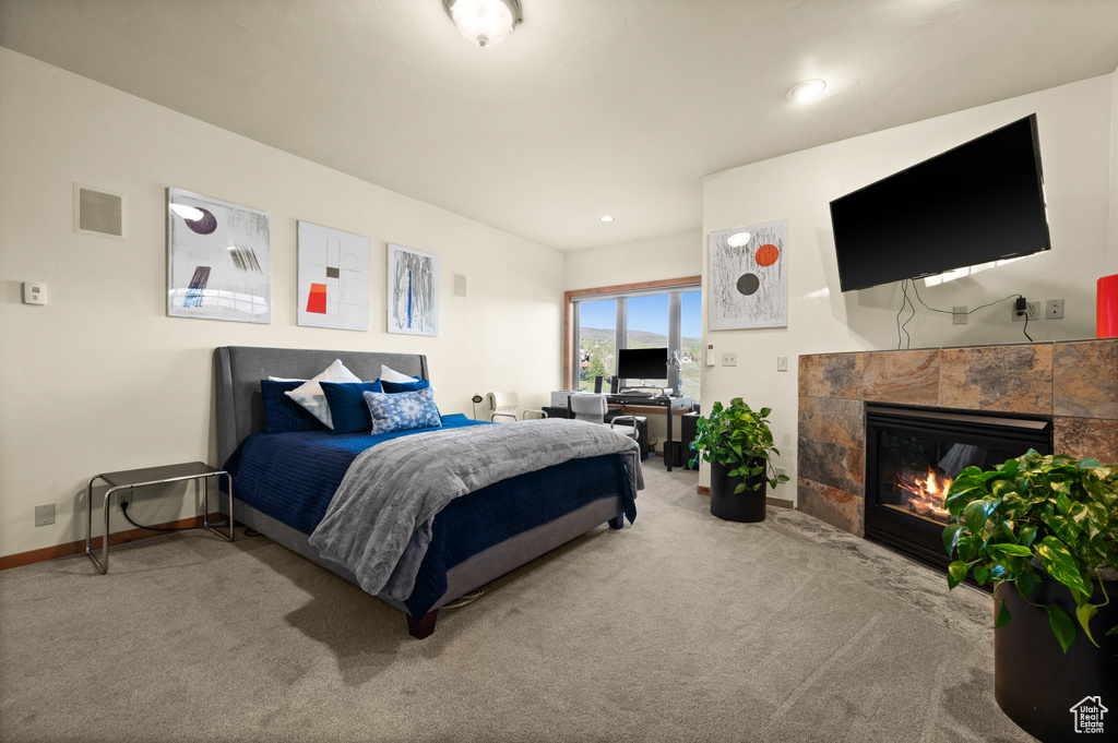 Bedroom featuring carpet flooring, a fireplace, and baseboards