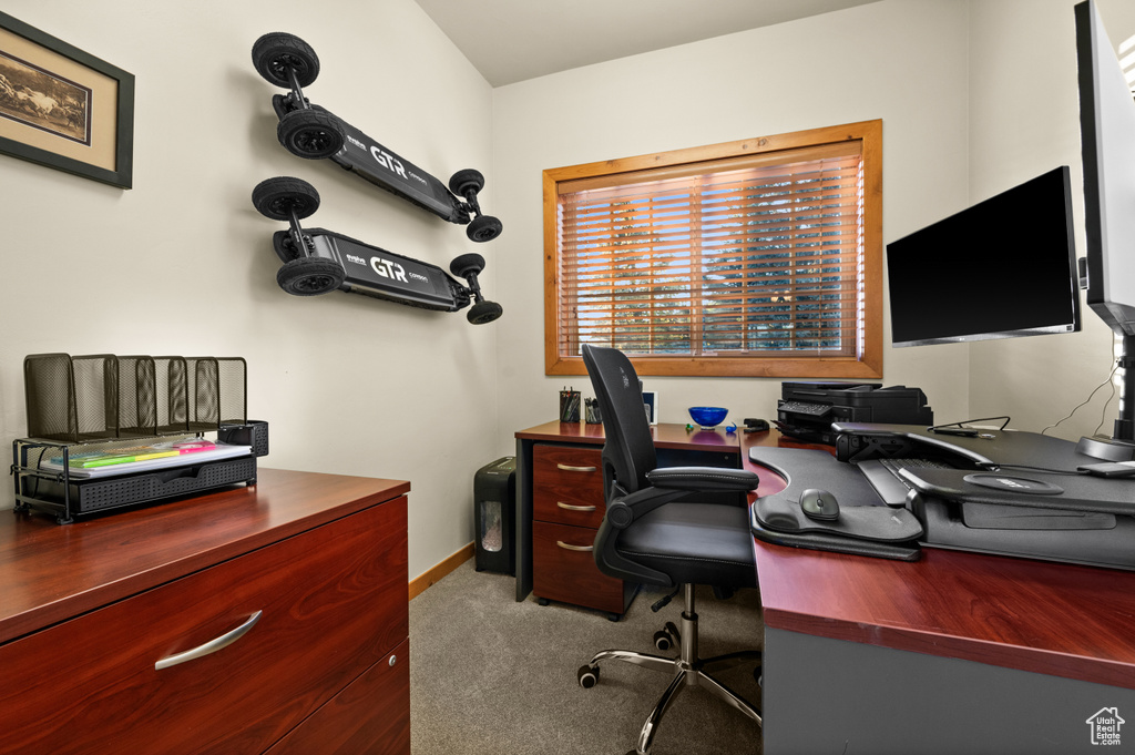Carpeted office space featuring baseboards