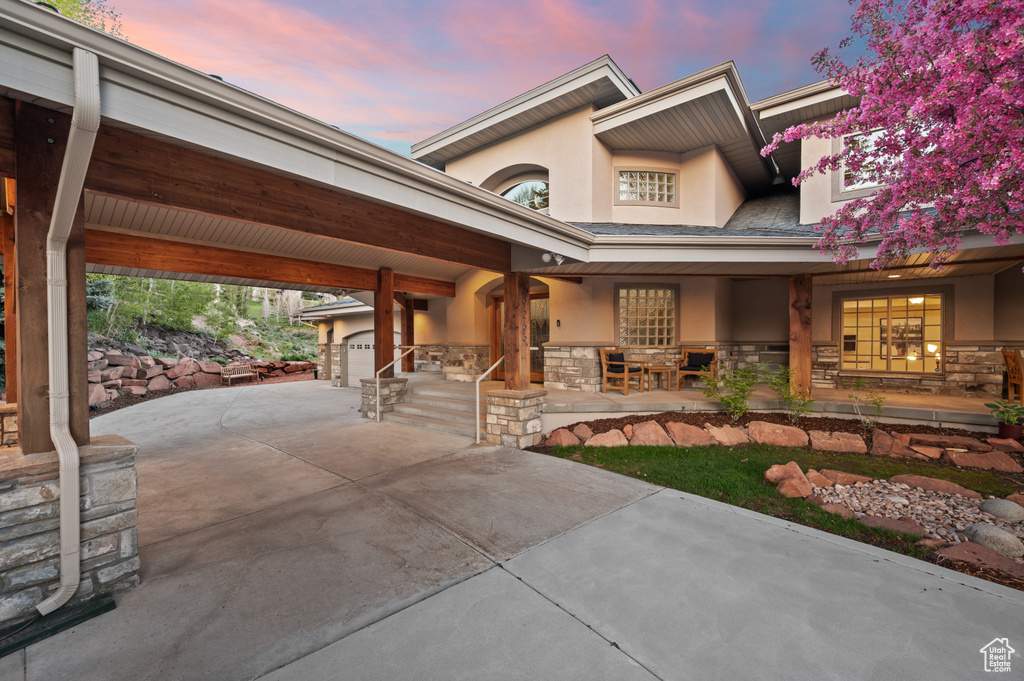 View of front of house featuring stucco siding and stone siding
