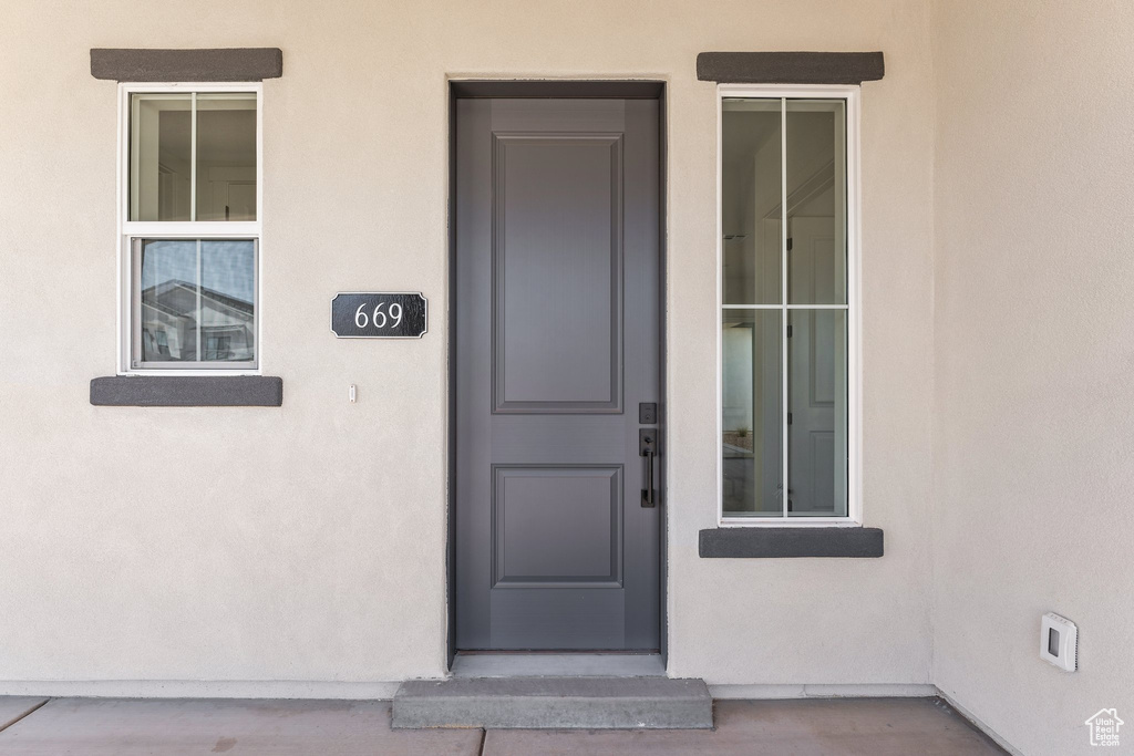 Property entrance with stucco siding