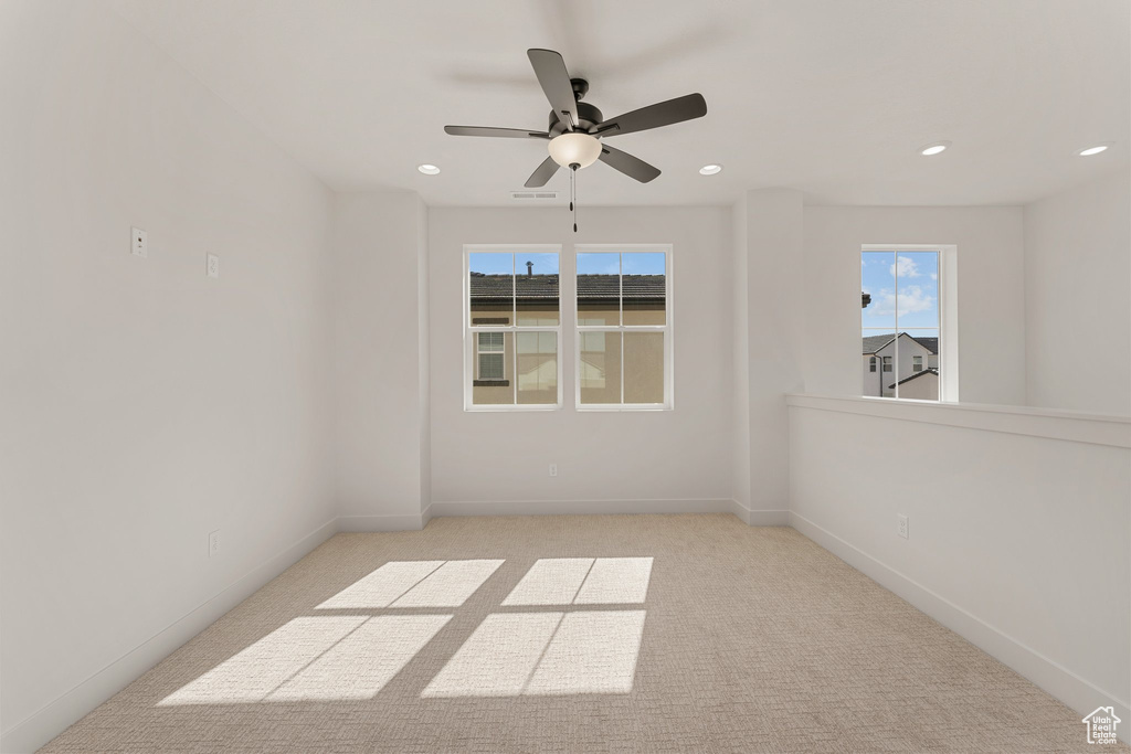 Empty room featuring carpet flooring, recessed lighting, a ceiling fan, and baseboards