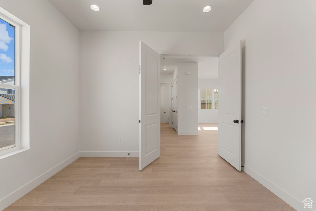 Empty room with light wood-style flooring, recessed lighting, baseboards, and a ceiling fan