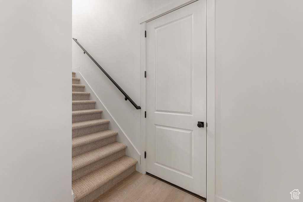 Stairs featuring wood finished floors