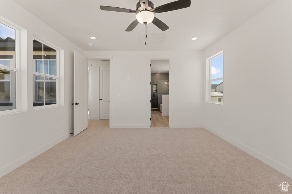 Unfurnished bedroom featuring light carpet, recessed lighting, baseboards, and ceiling fan