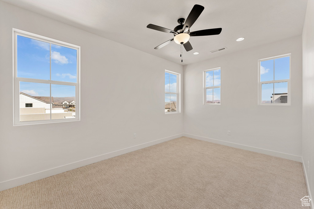 Carpeted spare room with baseboards, ceiling fan, and recessed lighting