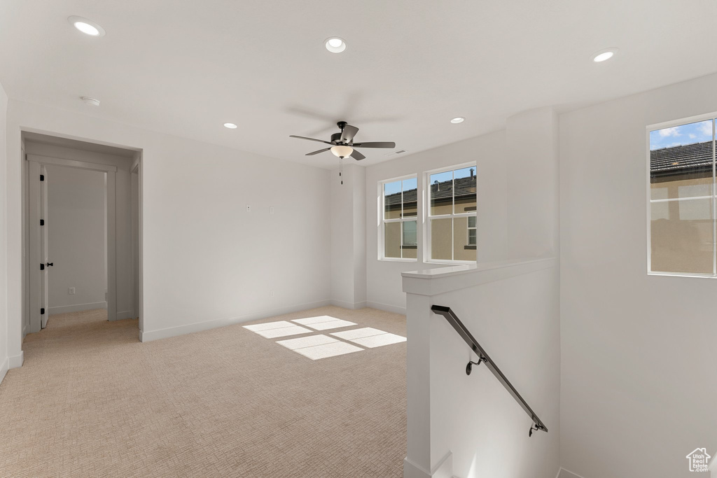 Empty room with light colored carpet, recessed lighting, baseboards, and ceiling fan