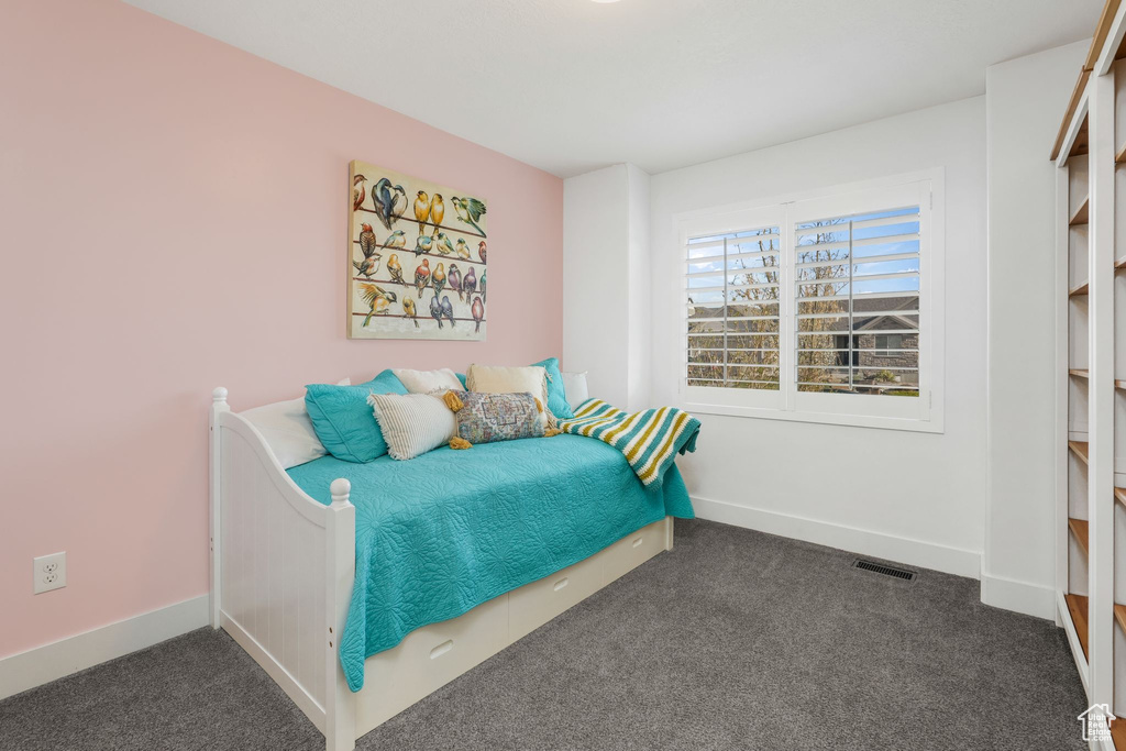 Carpeted bedroom with baseboards