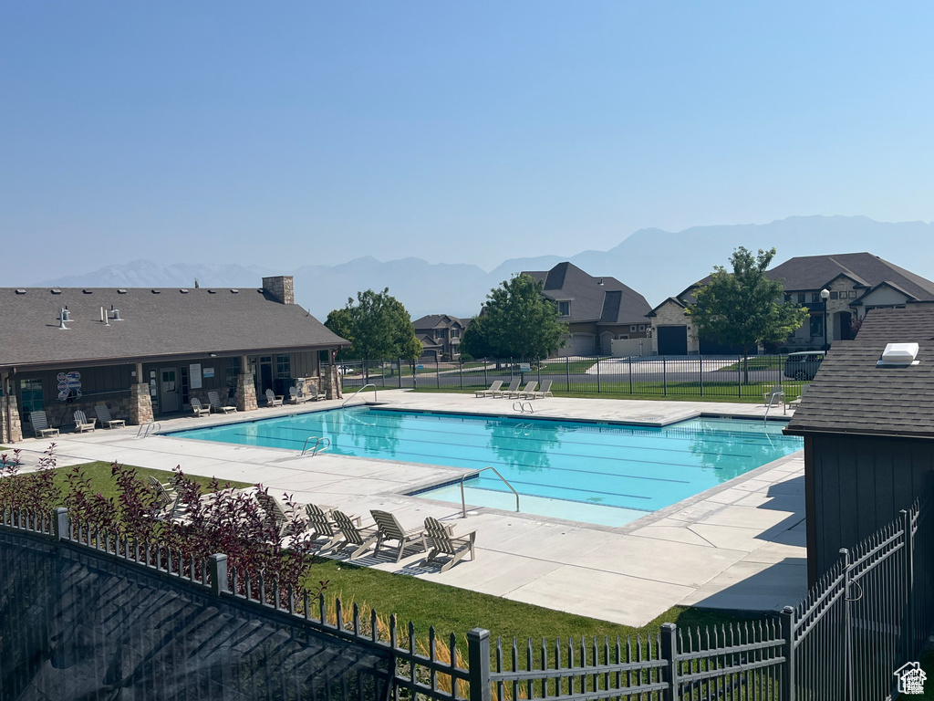 Community pool featuring a patio and a mountain view