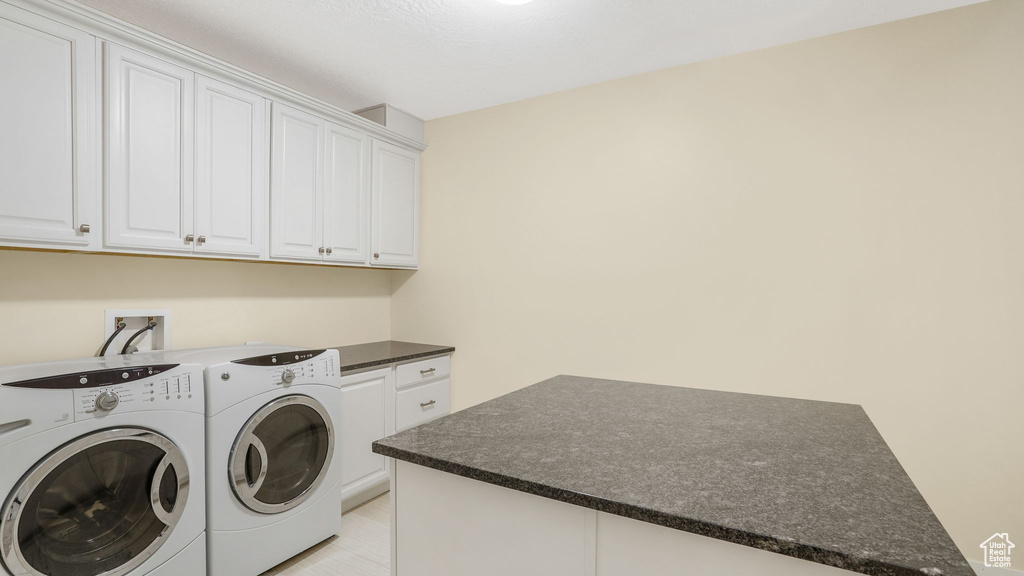 Laundry area with independent washer and dryer and cabinet space