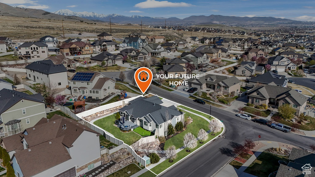 Aerial view of property\'s location with nearby suburban area and a mountainous background