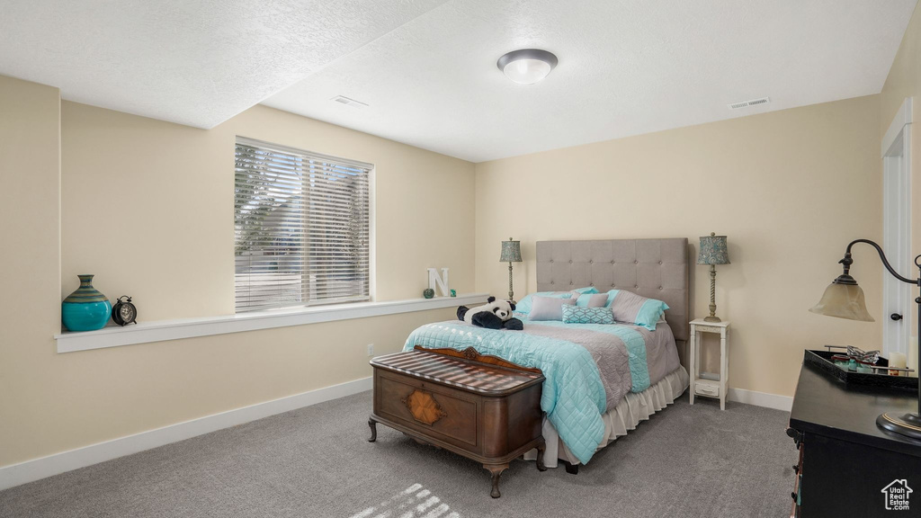 Carpeted bedroom featuring baseboards