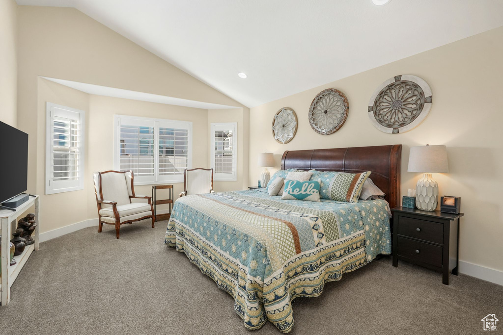 Bedroom with lofted ceiling, carpet flooring, baseboards, and recessed lighting
