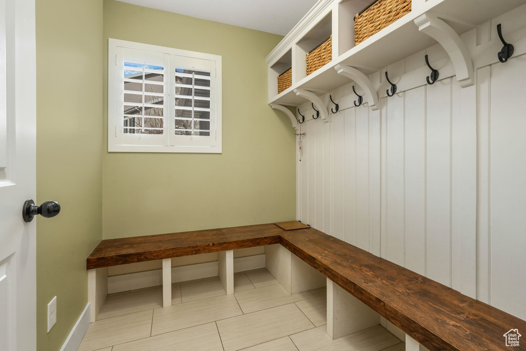 Mudroom featuring tile patterned floors and baseboards