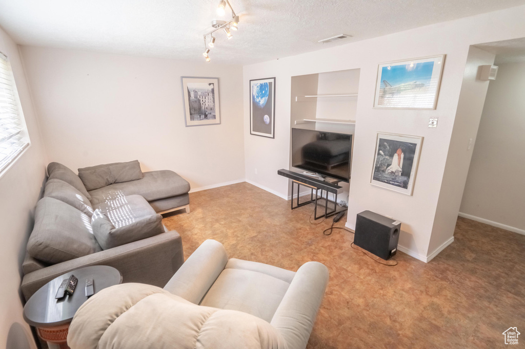 Living room with built in shelves and baseboards