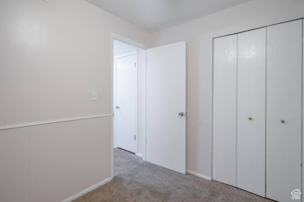 Unfurnished bedroom with carpet floors and a closet