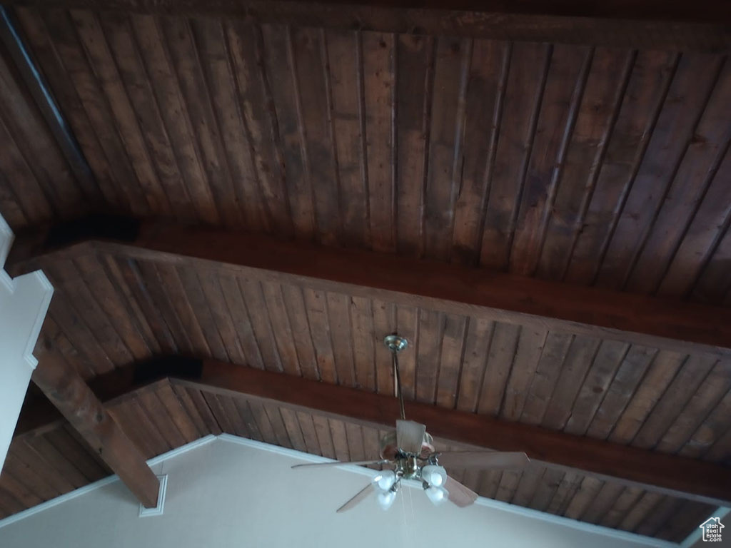 Detailed view of wooden ceiling with exposed beams and ceiling fan